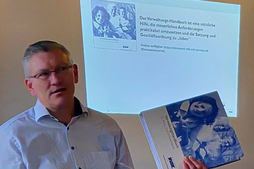 Dozent h&auml;lt einen Ordner