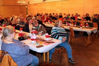 Menschen sitzen an schön gedeckten Tischen