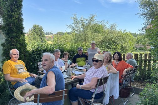 Im Schatten der alten B&auml;ume genoss die Besuchergruppe um VdK-Vorsitzende Silvia Ragaller (stehend) den Naturgarten und die kulinarischen K&ouml;stlichkeiten