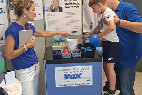 Die Kleinsten hatten Spaß an unserem Glücksrad Infostand mit Beratern und Kind