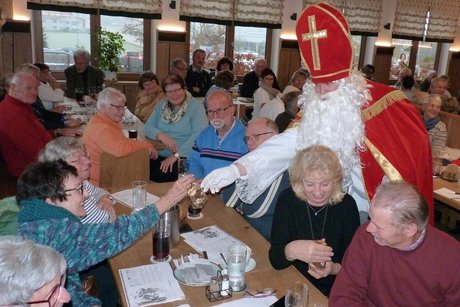 Nikolaus mit Krampus verteilt Geschenke an Besucher