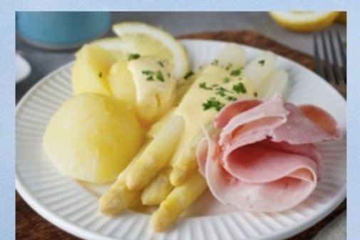 ein Teller mit Spargel, Kartoffeln, Schinken und Sauce Hollandaise