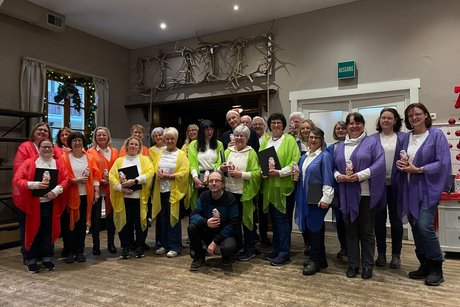 Chor posiert mit Dirigent und Gastgeber