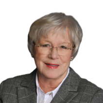Auf dem Bild ist eine Frau mit grauen Haaren, Brille und grau gemusterten Blazer zu sehen.