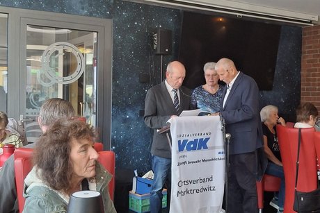 Drei Redner am Pult
