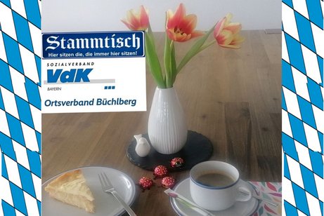 Zu sehen ist ein Holztisch mit Kaffee und Kuchen eingerahmt mit Herzen