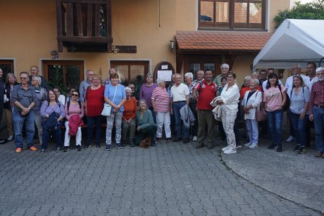 Die Gruppe der Teilnehmer sieht gl&uuml;cklich und zufrieden aus beim Eingang zum Weingut Alt in Ippesheim.
